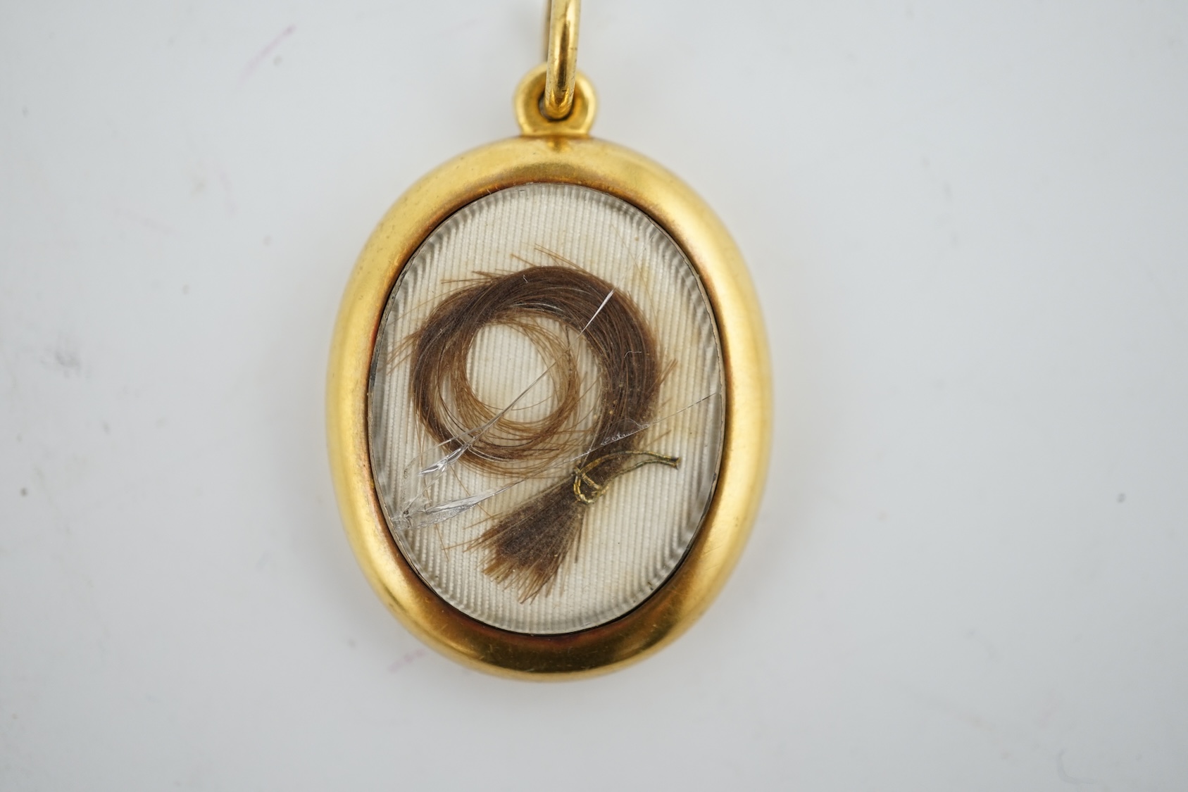 A yellow metal locket containing a lock of Napoleon I hair